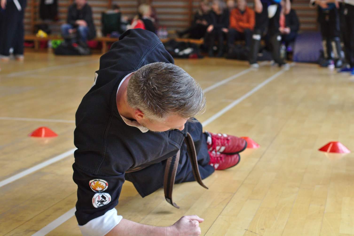 male student doing the plank at fusion kung fu grading