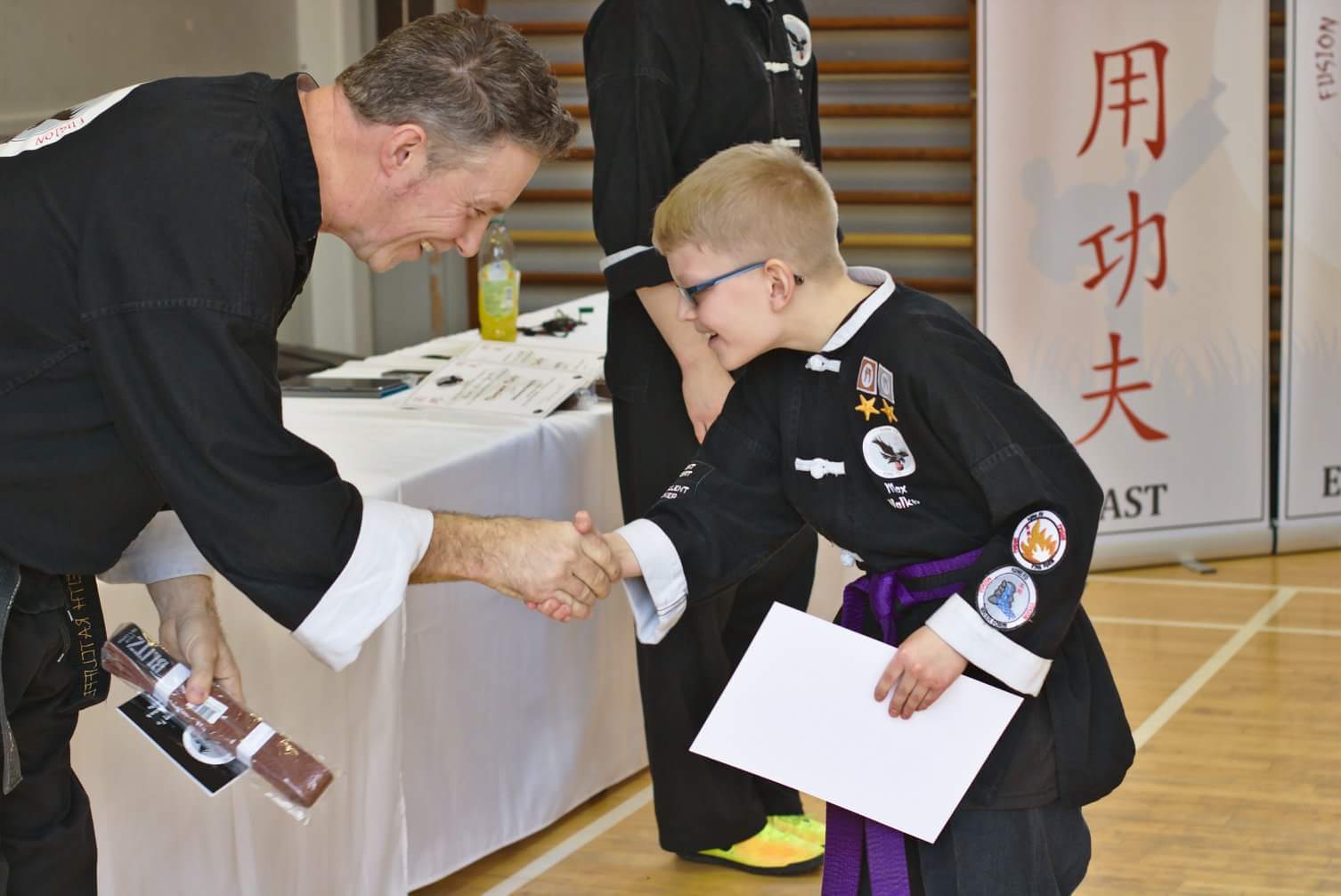 junior student receiving his brown belt at Fusion Kung Fu in Norwich